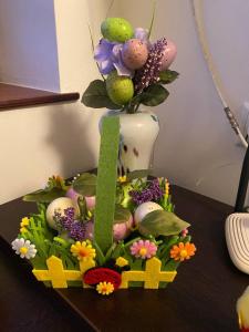 a vase filled with easter eggs and flowers on a table at Сирена in Sveti Vlas