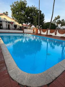a swimming pool with blue water at Beachfront Bungalow Rosarito Beach in Rosarito