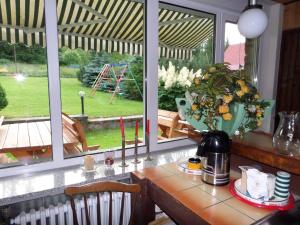 a kitchen with a table with a vase of flowers at Sylwia in Szklarska Poręba