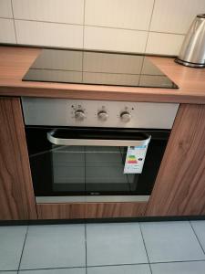 a stove in a kitchen under a counter at Apartment Andjela in Belgrade
