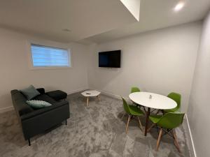 a living room with a couch and a table at NEW Modern and Bright Suite near WEM in Edmonton