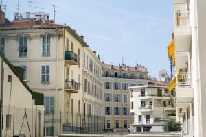 a group of buildings in a city at Appartements Massena in Nice +16 photos