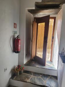 a door in a room with a fire hydrant at Estúdio Tia Anica in Reguengos de Monsaraz