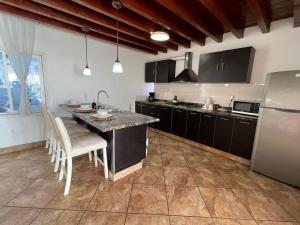 a kitchen with a large island in the middle at Beachfront Bungalow Rosarito Beach in Rosarito