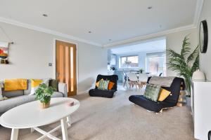 a living room with a couch and chairs and a table at StayRight 3 Bed House with Private Parking in Cardiff
