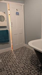 a bathroom with a white door and a sink at Cute Fisherman's Cottage in the Heart of Brighton in Brighton & Hove