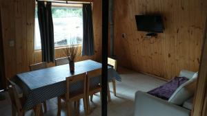 a dining room with a table and a window at La Torre del Rio in Lago Meliquina