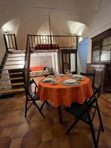 a dining room with a table and a loft at Il Loft In Piazza 2 in Dolceacqua