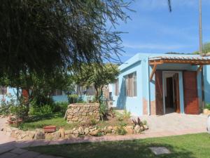 una piccola casa blu con un muro di pietra di Villa dei Narcisi a Solanas