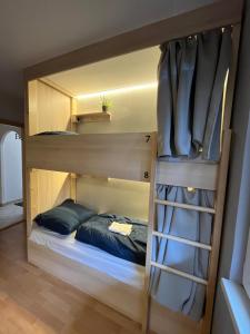 a room with a bunk bed and a ladder at Bad Stuben Hostel in Turčianske Teplice