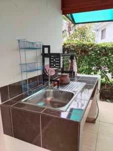 a kitchen with a large stainless steel sink at F&F Mae Phim Villa Rayong in Ban Ang