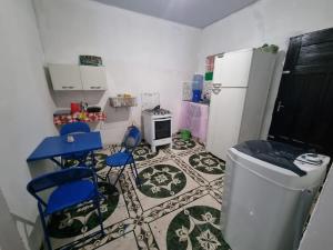 a kitchen with two blue chairs and a refrigerator at Canto da Sereia - Casa in Soure