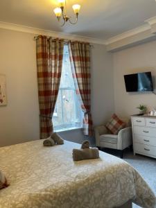 a bedroom with a bed with two towels on it at Rivendell Guest House in Keswick