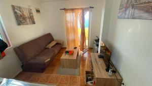 a living room with a couch and a table at Extra lokacija!!!!! in Sutomore