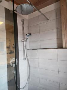 a shower with a shower head in a bathroom at Ferienhaus Bad Feilbach in Bad Feilnbach