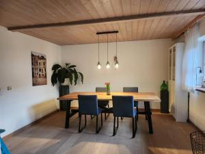 a dining room with a wooden table and chairs at Ferienhaus Bad Feilbach in Bad Feilnbach