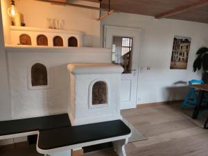 a living room with a stove in the middle at Ferienhaus Bad Feilbach in Bad Feilnbach