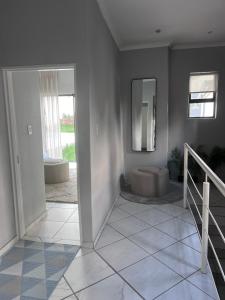 a white bathroom with a toilet and a mirror at Lanina Self Catering Apartments in Johannesburg +27 photos
