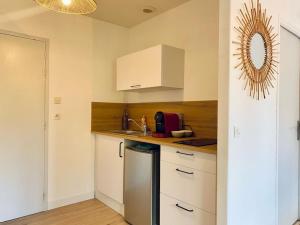 a kitchen with white cabinets and a counter top at Appartement proche Centre-ville in Saint Lo