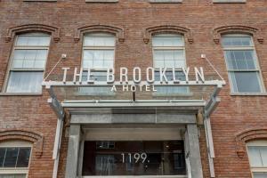 a brick building with a sign over a door at The Brooklyn in Brooklyn