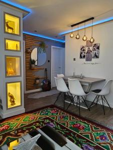 a dining room with a table and chairs and a rug at Iris Stay in Edinburgh