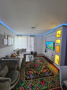 a living room with a couch and a tv at Iris Stay in Edinburgh
