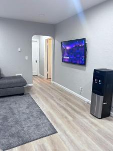 a living room with a couch and a flat screen tv at Cozy Sumner Home, Shops & Dining Nearby in Sumner