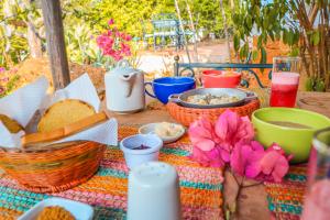 a picnic table with baskets of food and bread at Hotel Casa El Mandarino in Barichara +32 photos