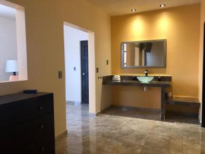 a bathroom with a sink and a mirror at Tres Iguanas Apart Hotel - New, cozy & spacious flats, short walk to beach in Loreto