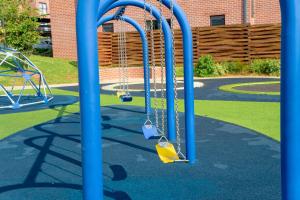 a playground with two swings in a park at 15 Elizabeth Place - Luxury Apartments, Free Wi-Fi in Midrand