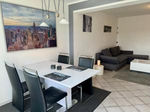 a living room with a white table and chairs at Schnütgenhof Appartements in Attendorn