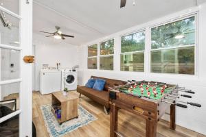 a living room with a couch and a foosball table at Modern Home Near UF, Stadium - Private Gazebo in Gainesville