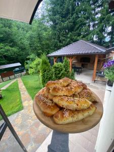 a plate of pastries on a table in a yard at Forest House Bosnia in Busovača