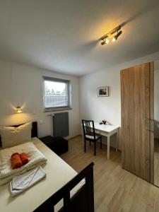 a bedroom with a bed and a table and a desk at Haus Ostseestrand36 in Timmendorfer Strand