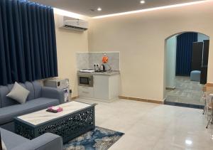 a living room with a couch and a table at Al Baida Suites Al Salam Branch in Al Madinah