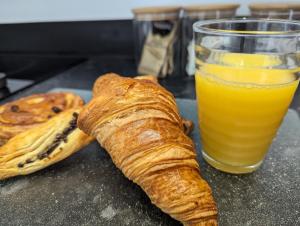a table with a glass of orange juice and a croissant at The boot factory in Leicester