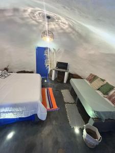 a bedroom with a bed and a bench and a table at Bahareque glamping in Barichara