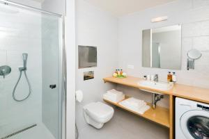 a bathroom with a sink and a washing machine at Residence Trafick in Prague +82 photos