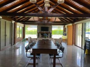 a dining room with a large wooden table and chairs at Hostal del Sol - Fisherton in Rosario