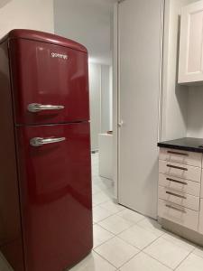 a red refrigerator sitting in a kitchen with at Appartement Seine 391 in Nogent-sur-Seine +8 photos
