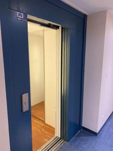 a blue wall with a mirror in a room at Appartement Seine 391 in Nogent-sur-Seine