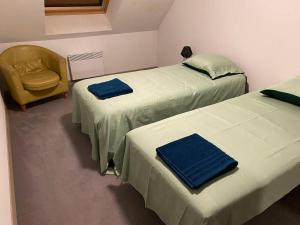 a room with two beds and a chair in it at Appartement Seine 391 in Nogent-sur-Seine