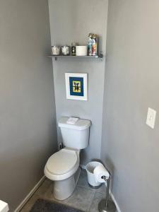 a bathroom with a white toilet in a room at Sycamore Suite/ Wi-Fi & office in Big Spring