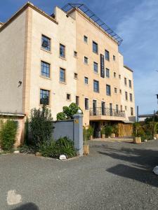 a large brick building with a gate in front of it at COMFORT E SUITES in Nairobi