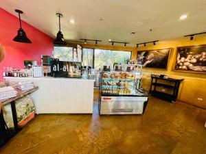 a store with a bakery with a counter in a room at Suite hotelera llanogrande in Rionegro