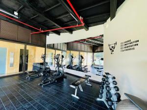 a gym with treadmills and elliptical machines at Suite hotelera llanogrande in Rionegro