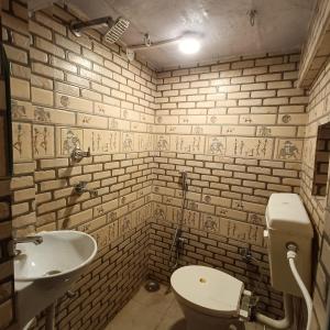 a bathroom with a white toilet and a sink at Feel Aesthetic Kashi Home Stay in Varanasi