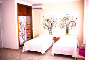Postel nebo postele na pokoji v ubytování Hotel Sur Utopia