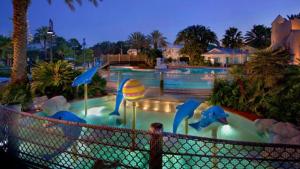 a pool with a water slide in a resort at Disney's Key West Resort Studio room sleeps 4 in Orlando