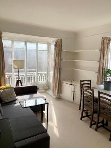 a living room with a couch and a table at Cozy Entire Flat walking to Hyde Park in London